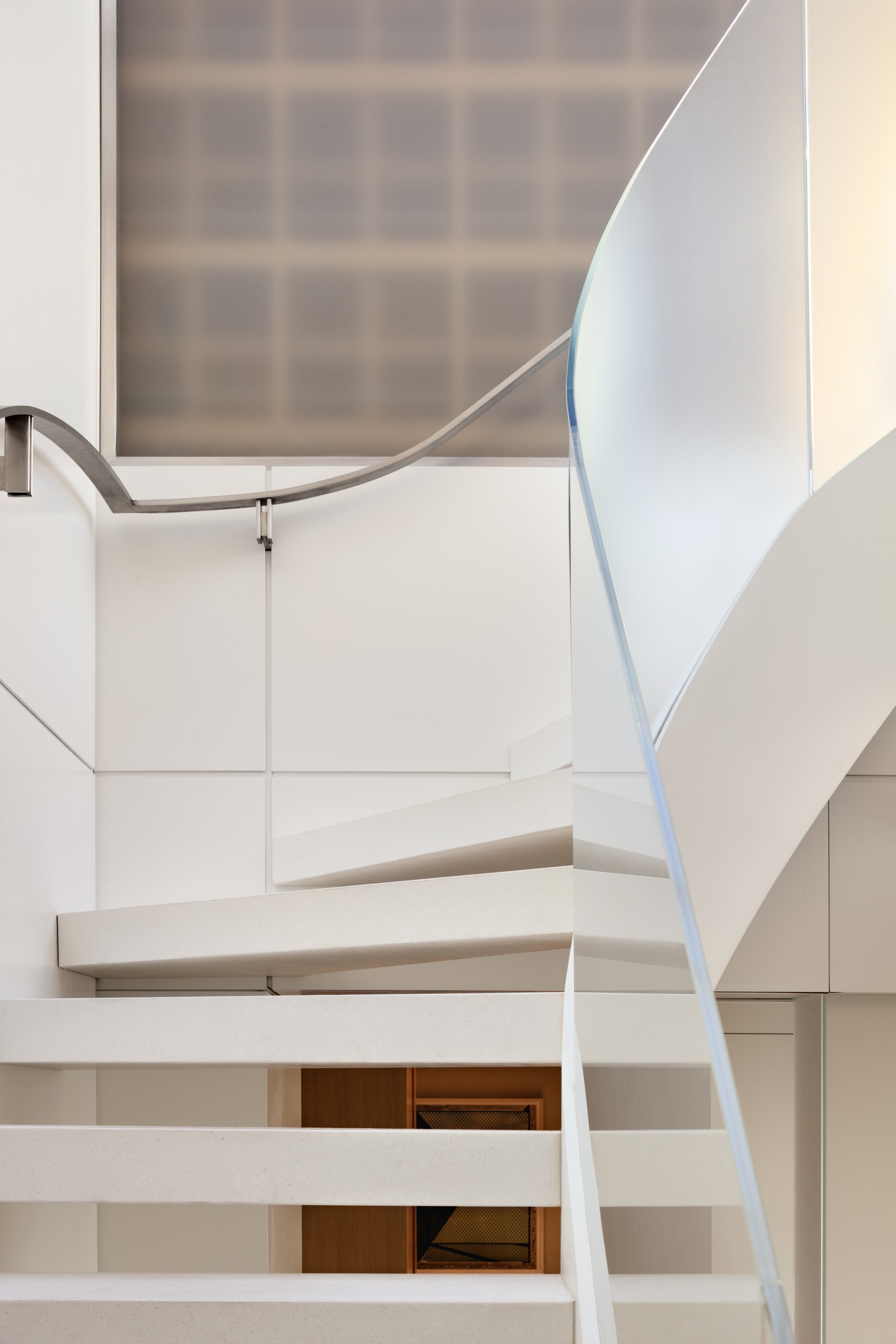 Logan Penthouse — sculptural stair and skylight